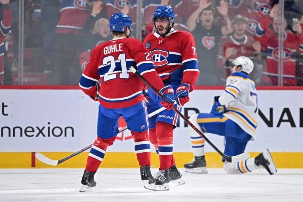 Montreal's Kirby Dach and Kaiden Guhle celebrate a goal in a playoff game against Buffalo.